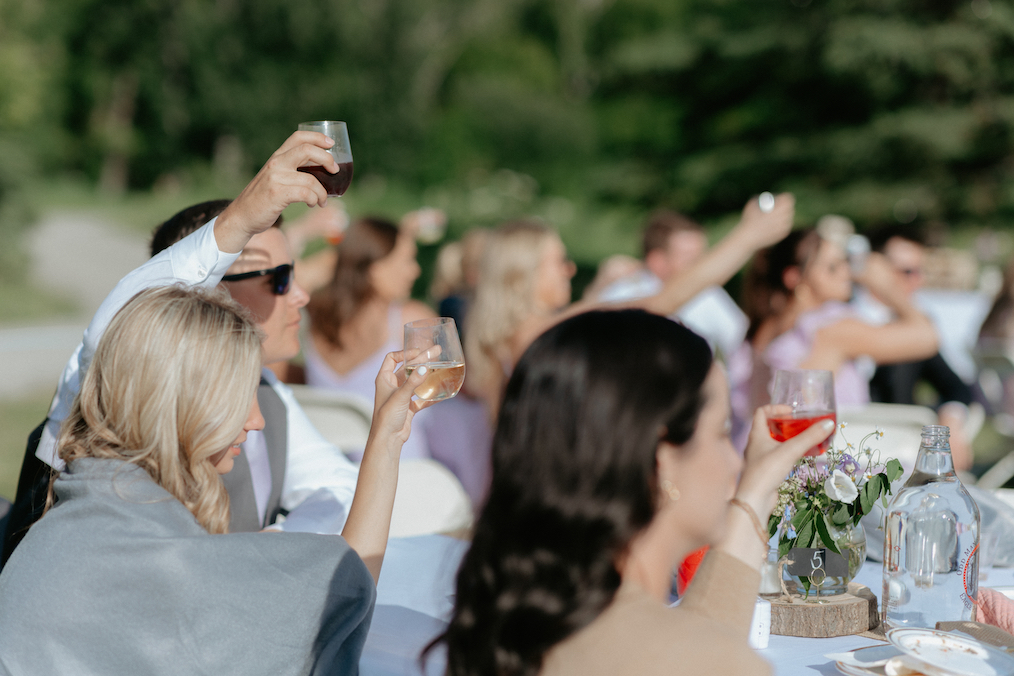 Family and friends toasting to the newlyweds. 