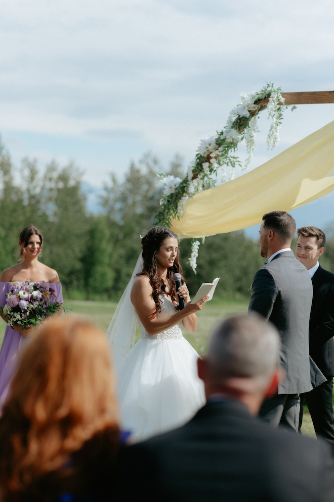 Woman reading her wedding vows in Alaska.