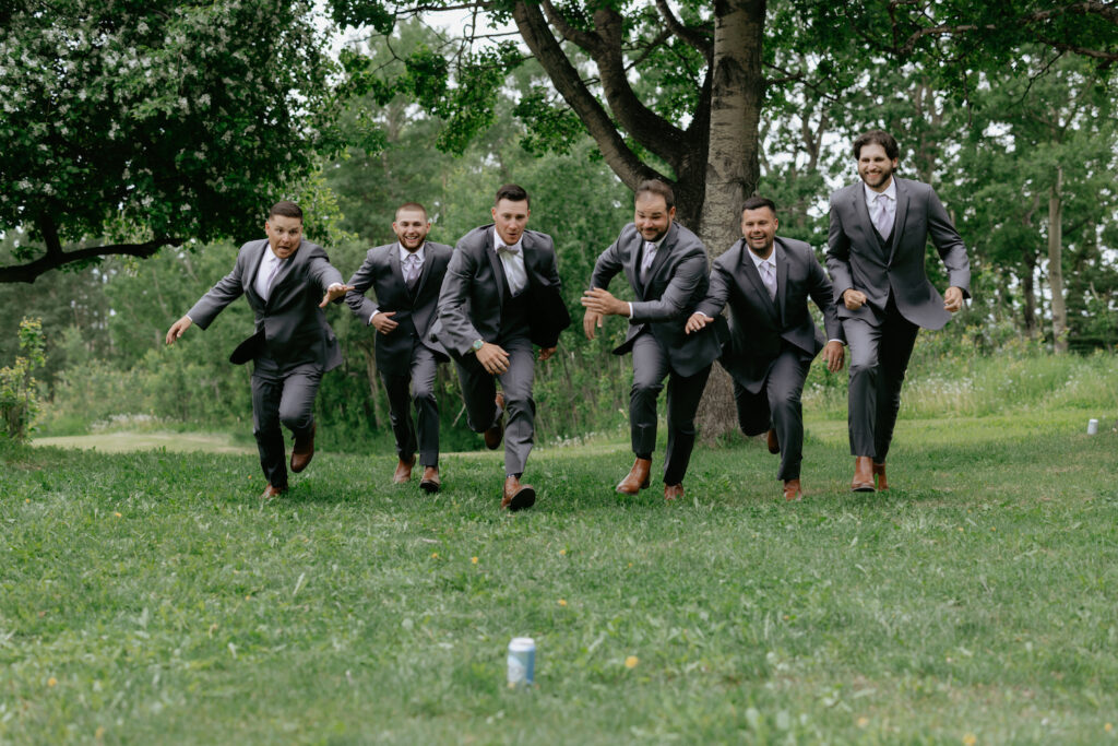 A group of men running toward a can of beer for wedding photos in Alaska