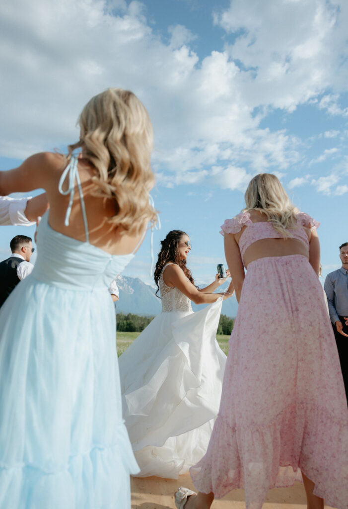 Woman dancing while wearing a wedding dress in Alaska.