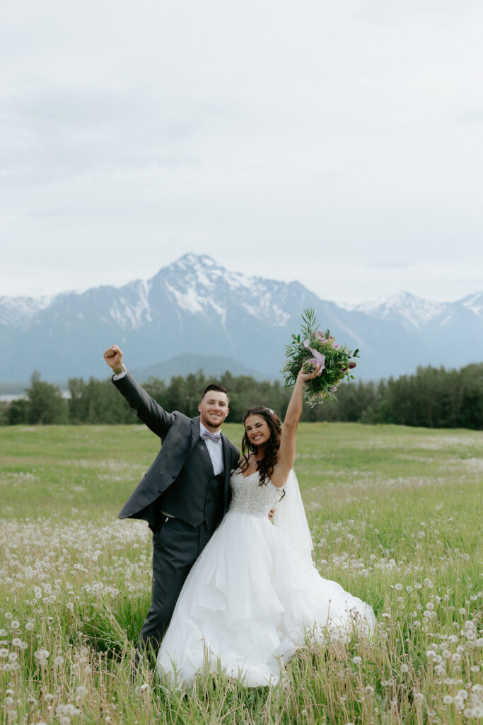 Couple celebrating on their wedding day while surrounded by the mountains. 