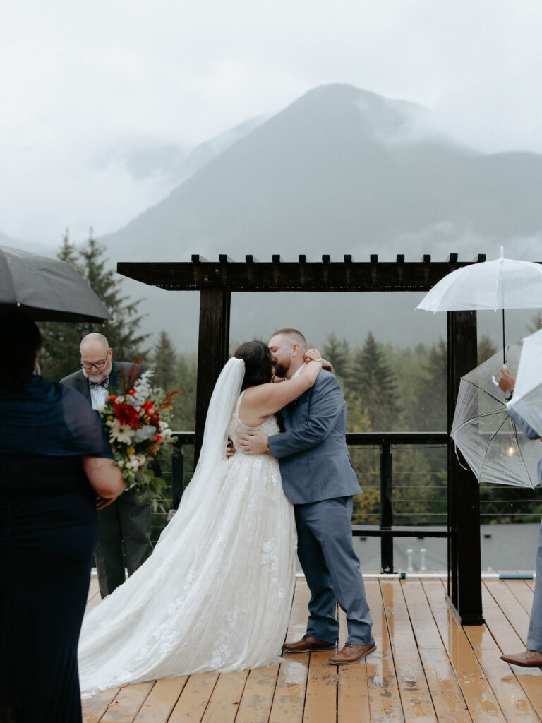 Couple kissing in front of the mountains 