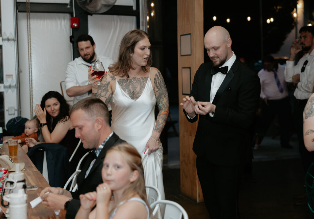 A couple standing and talking to one another during their reception 