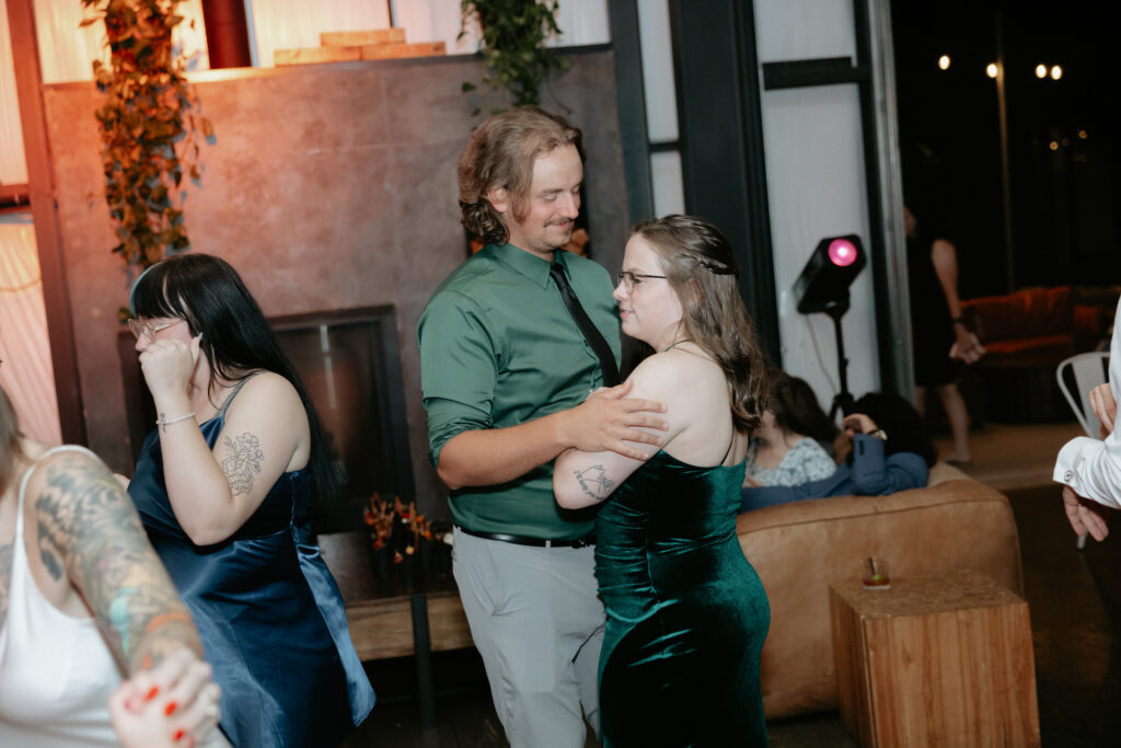 A couple holding onto one another and dancing.