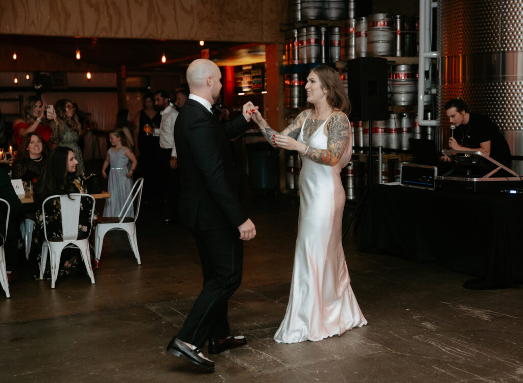 A couple holding hands and dancing. 