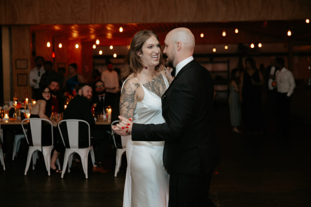 A couple holding hands and dancing. 