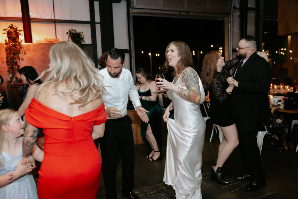 A group of people dancing in a circle. 