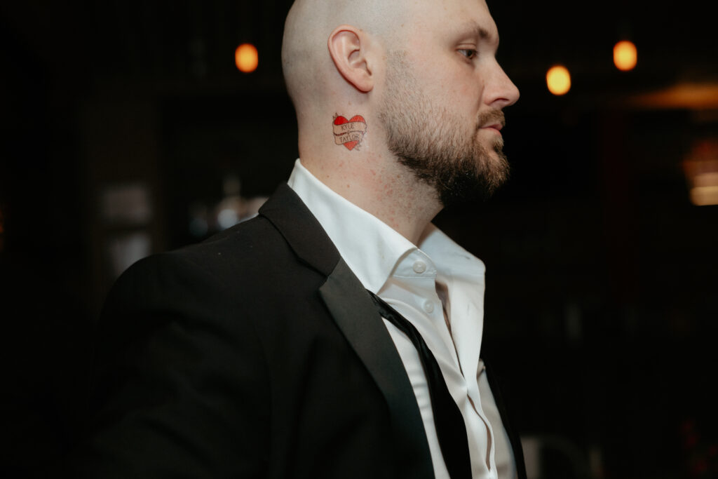 A temporary tattoo on a man's neck. 