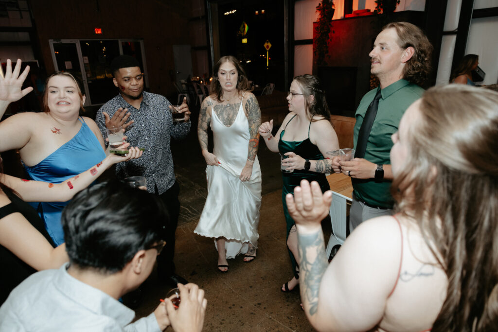 A group of people dancing in a circle. 