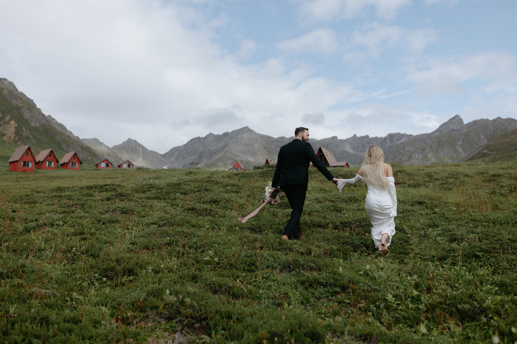 A couple holding hands and walking together in Hatcher Pass.
