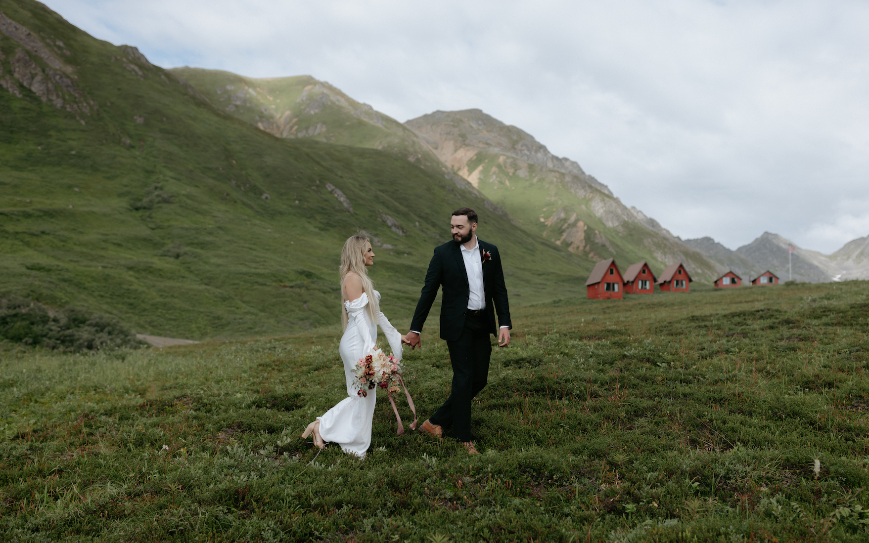Couple walking and holding hands in Hatchers Pass. A common wedding location in Alaska. 