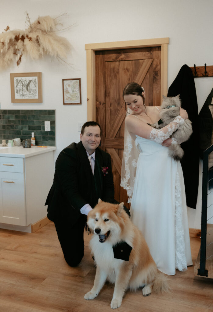 A couple holding their four legged friends. 