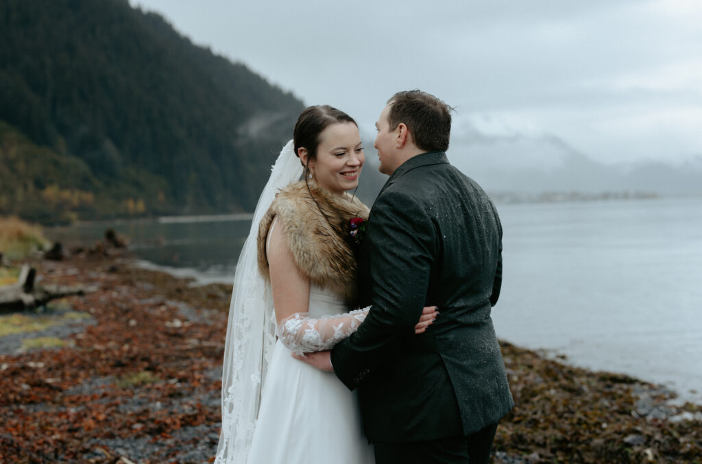 Woman laughing as her partner pulls her close. 