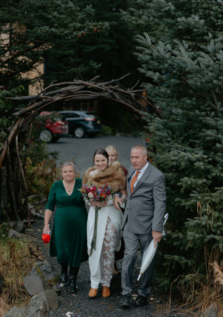 The bride and her family walking down the aisle together