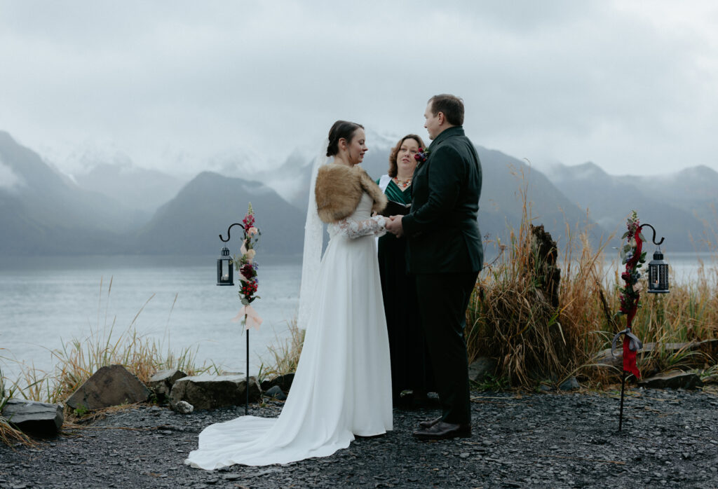 A couple holding hands and exchanging vows with one another