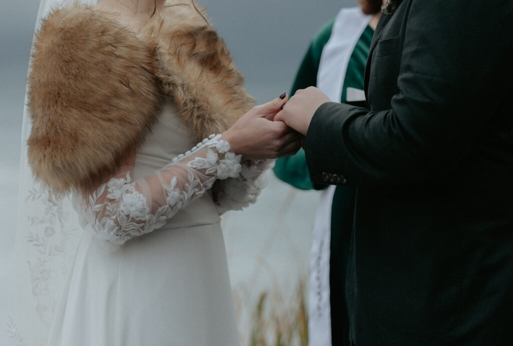 Couple holding onto one another's hands.