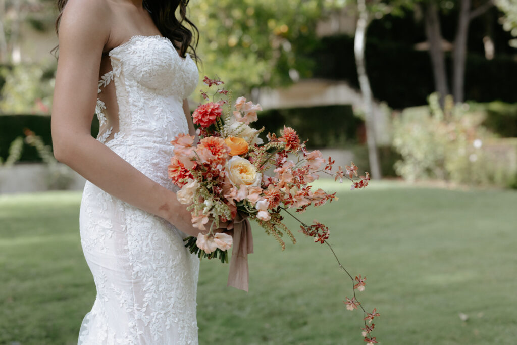 A woman holding a vibrant floral bouquet. 