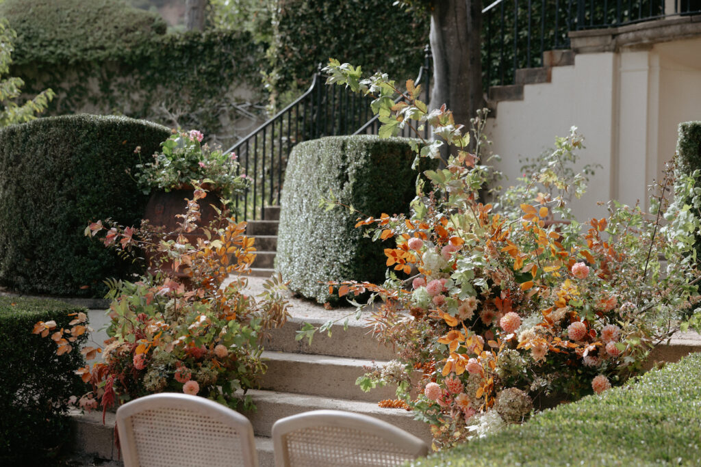 Orange and pink florals set up in a floral arrangement. 