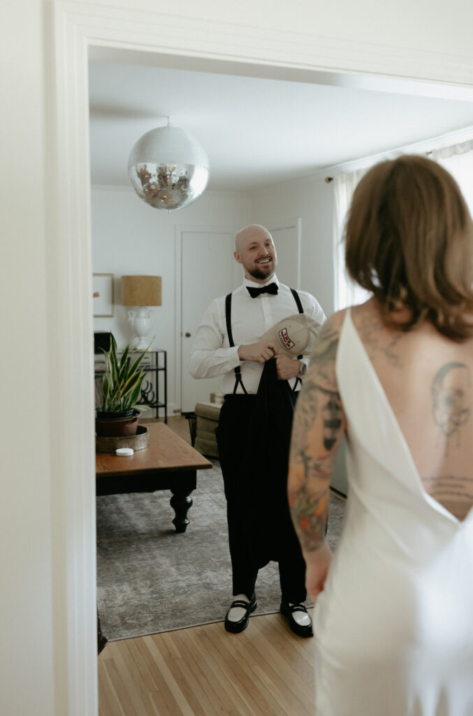 A man taking off his hat as he see's his wife for the first time/ 