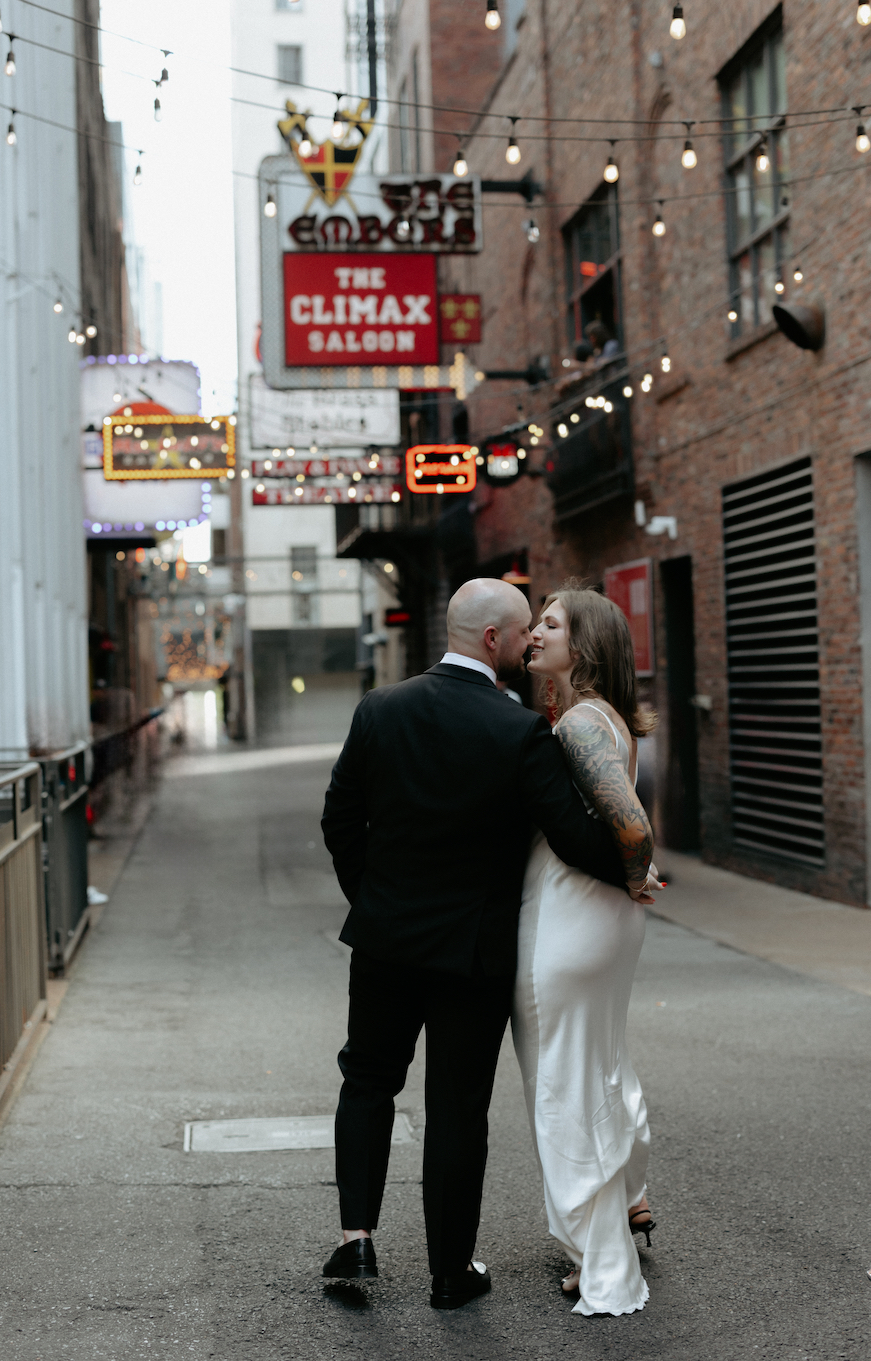 A couple walking together in printers alley. 