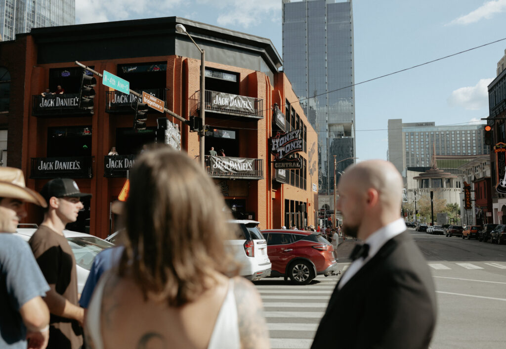 A couple getting ready to cross the street. 