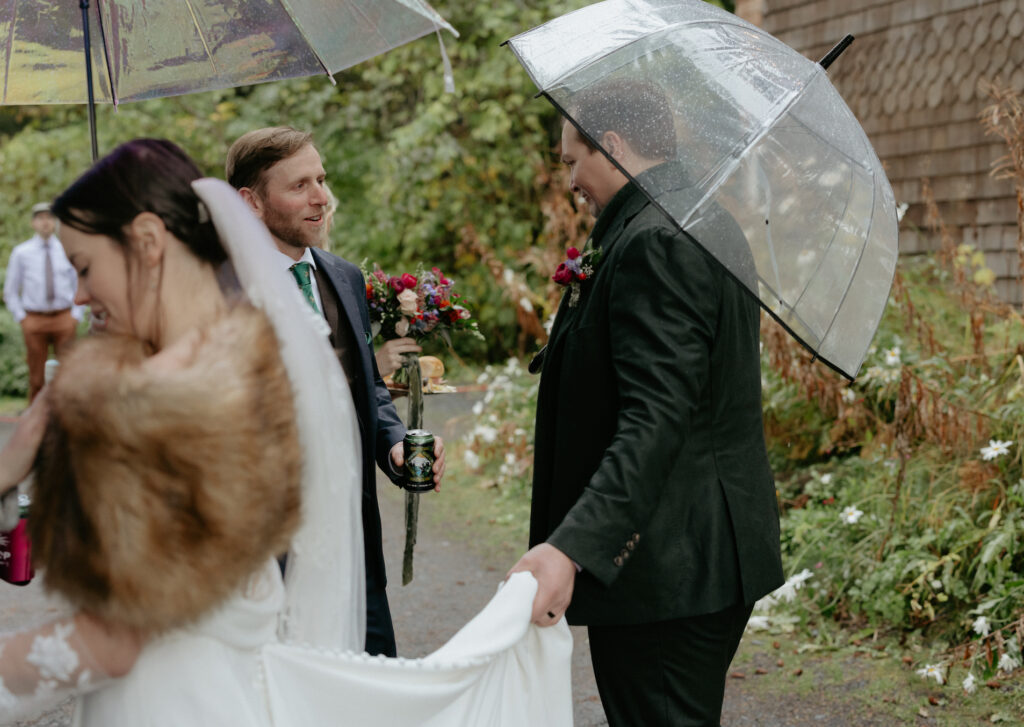 Man holding woman's dress as she greets people. 