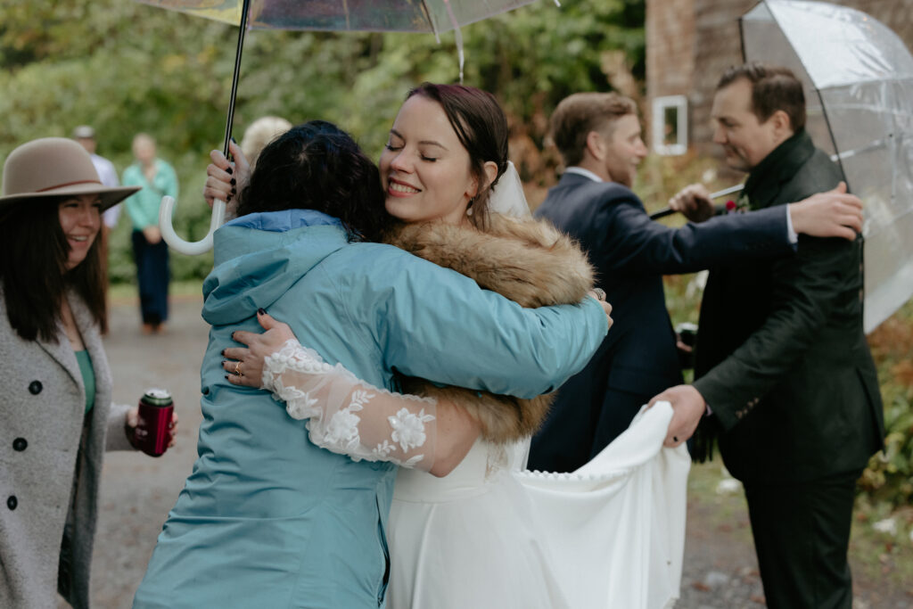 Woman hugging another woman who is wearing a blue jacket