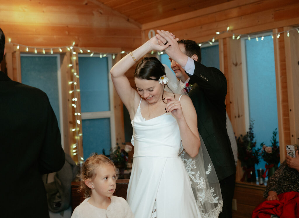 Man holding woman's hand and spinning her around. 