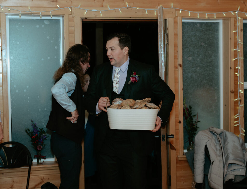 Man holding a box of cookies. 