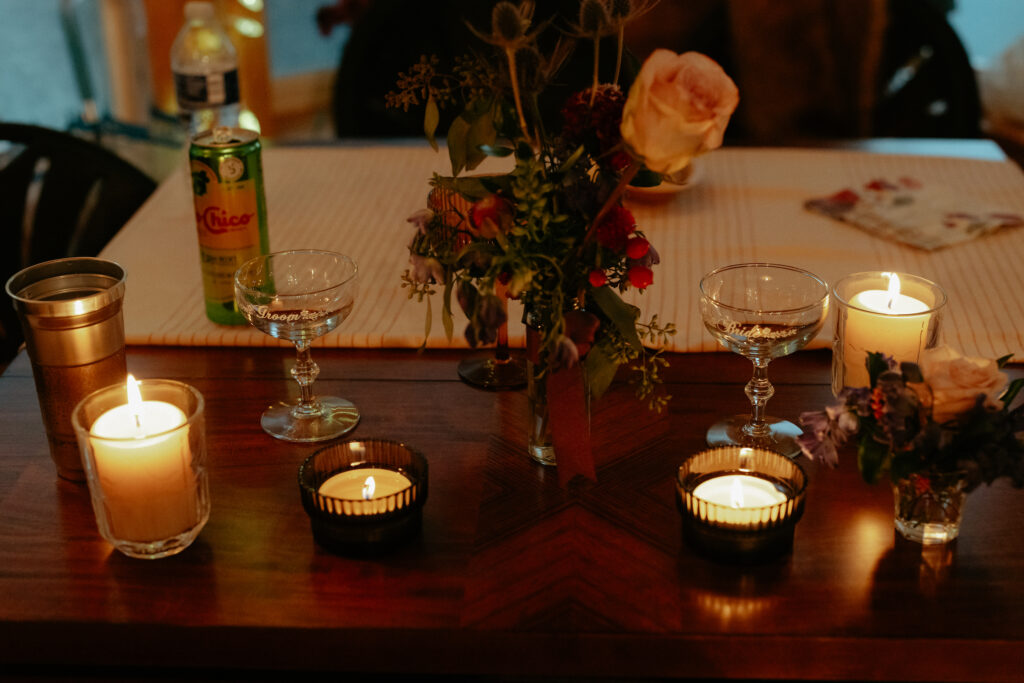 Bride and groom glasses by candlelight. 