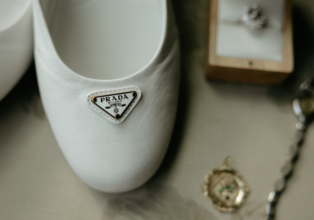 White prada shoes placed on a chair. 