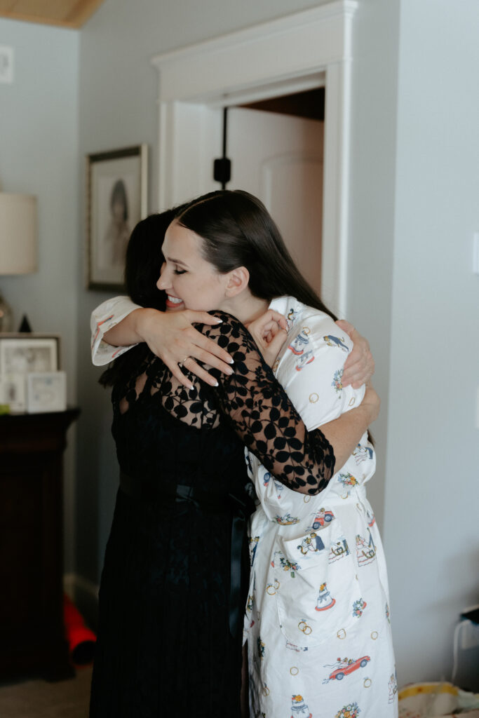 A mother and daughter hugging while getting ready. 