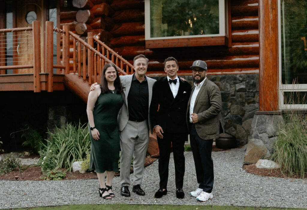 A group of people standing together outside a home. 