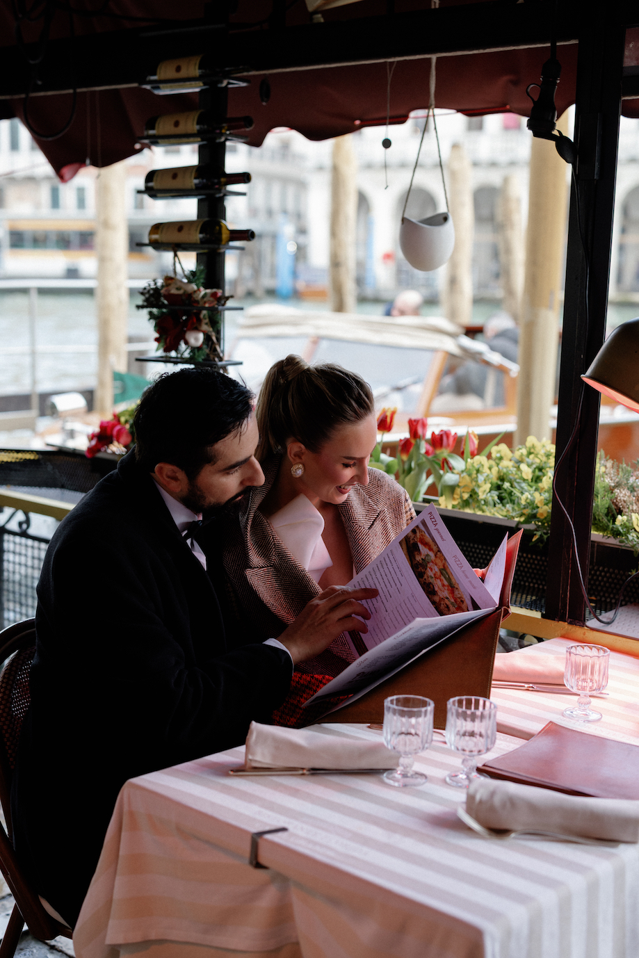 A couple reading a menu at a cute restaurant