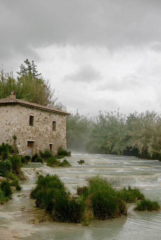 A building next to hot springs on a cloudy day.