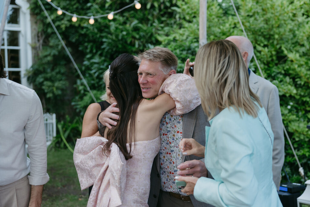 A woman hugging her father.