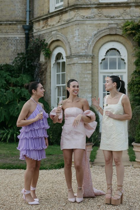 A group of girls wearing fun dresses for a rehearsal dinner at Pylewell Park.