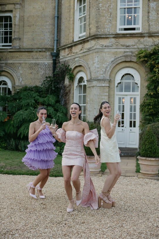 A group of girls drinking champagne outside the venue
