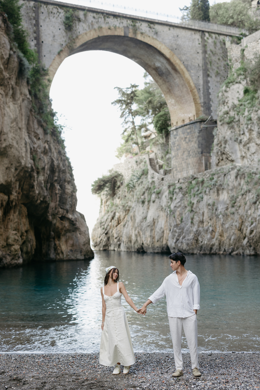 A couple holding hands and walking.