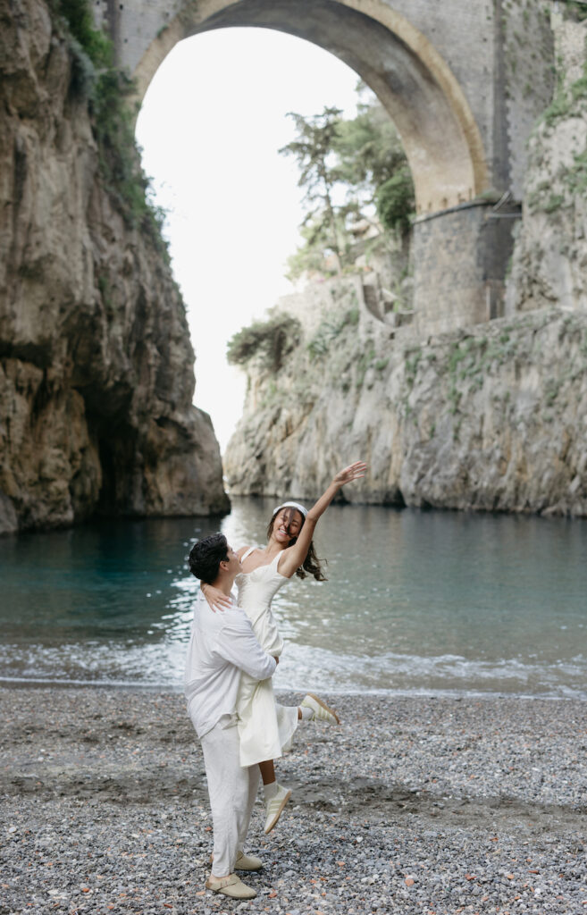A man picking up a woman in front of fiordo di furore.